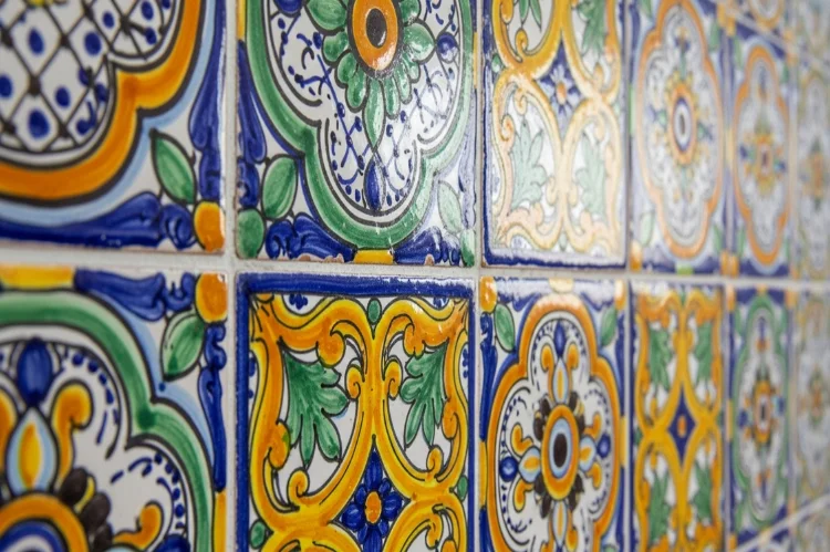 colorful Talavera tiles with traditional Spanish patterns, vibrant blues and yellows.