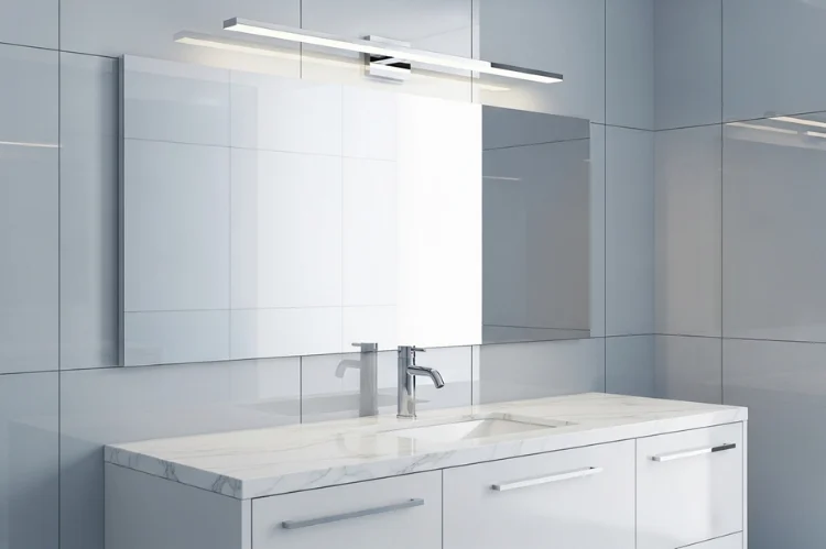 Contemporary bathroom vanity with chrome vanity light bar above mirror, matching chrome faucet and drawer pulls, white marble countertop, cool-toned tiles