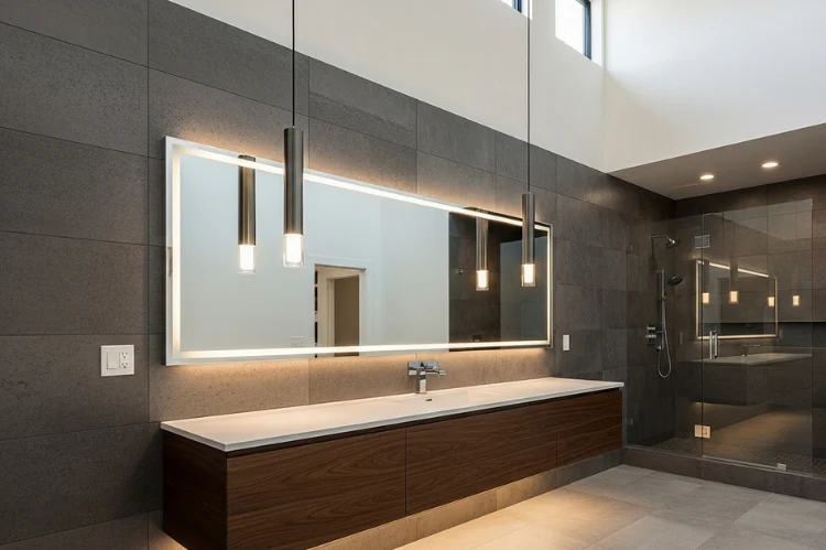 Two hanging pendant lights over bathroom vanity mirror