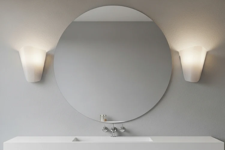 Round bathroom mirror with two modern wall sconces on either side, soft angular sconces contrasting curved mirror, balanced shadow-free lighting, minimalist bathroom