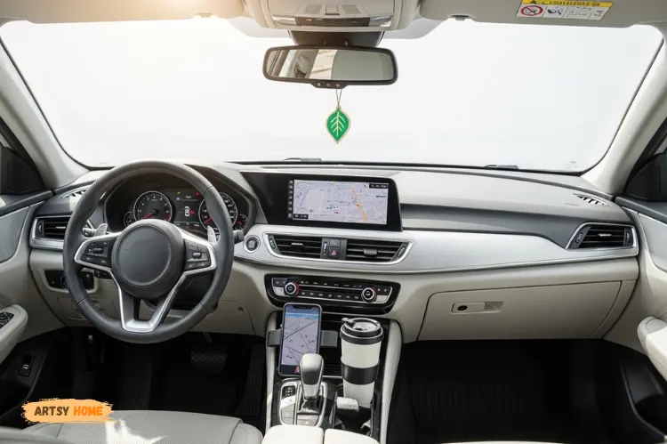 Car interior with fresh and clean look, air freshener hanging, bright lighting.