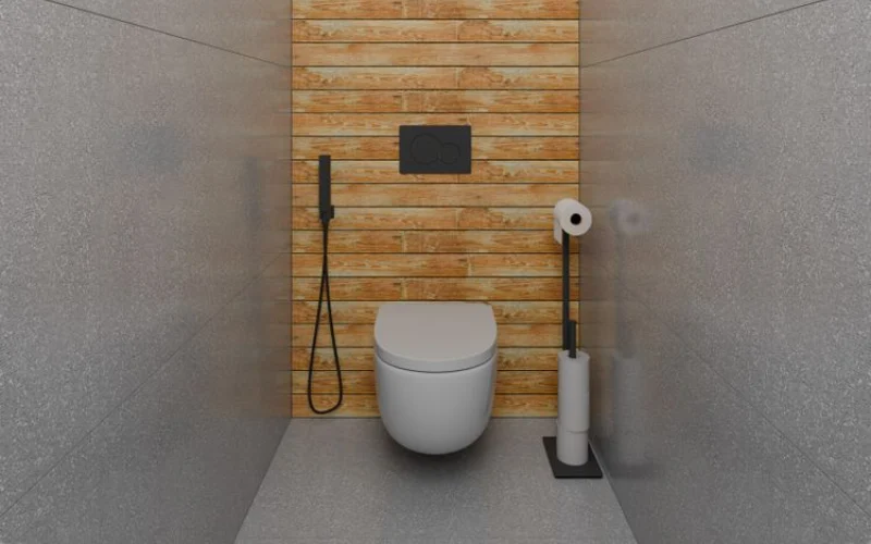 Wall-hung toilet against a wood accent wall in a modern bathroom.